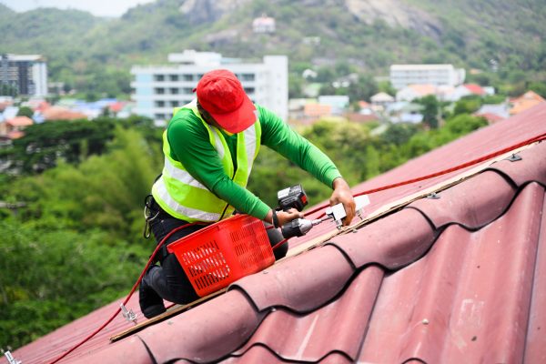 Professional engineer worker installing solar panels system on rooftop, Clean energy sources, Concept of alternative and renewable energy, Environment and technology concept